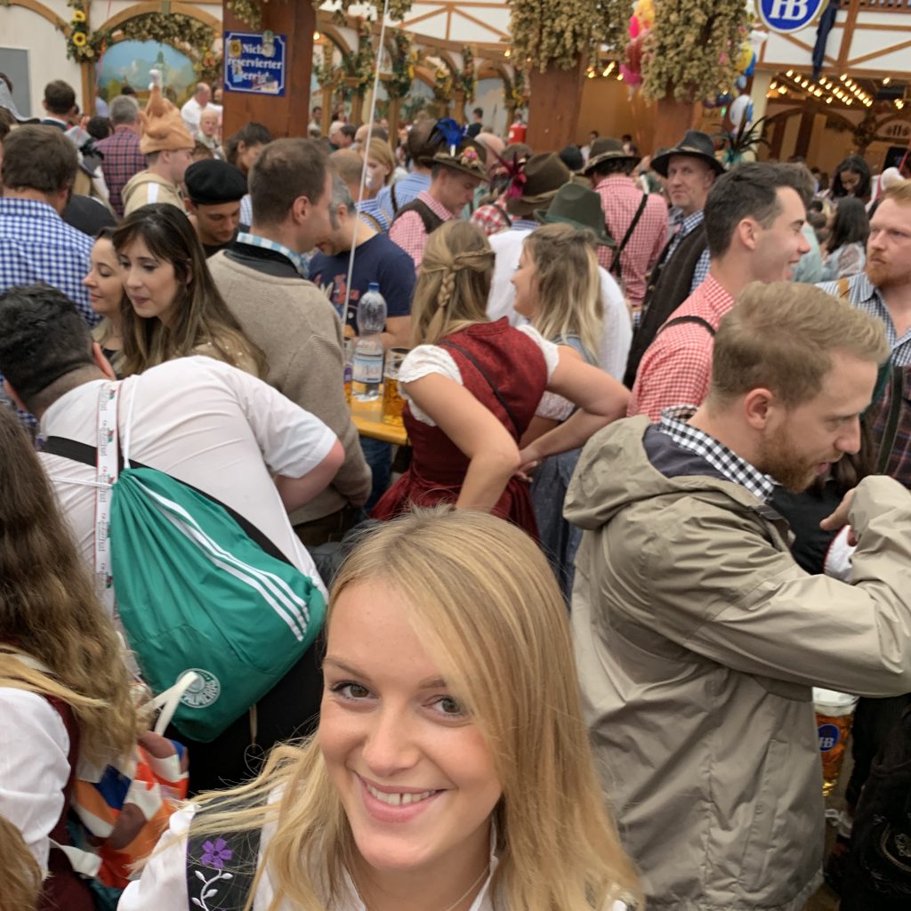 A woman with a beer in a tent at Oktoberfest