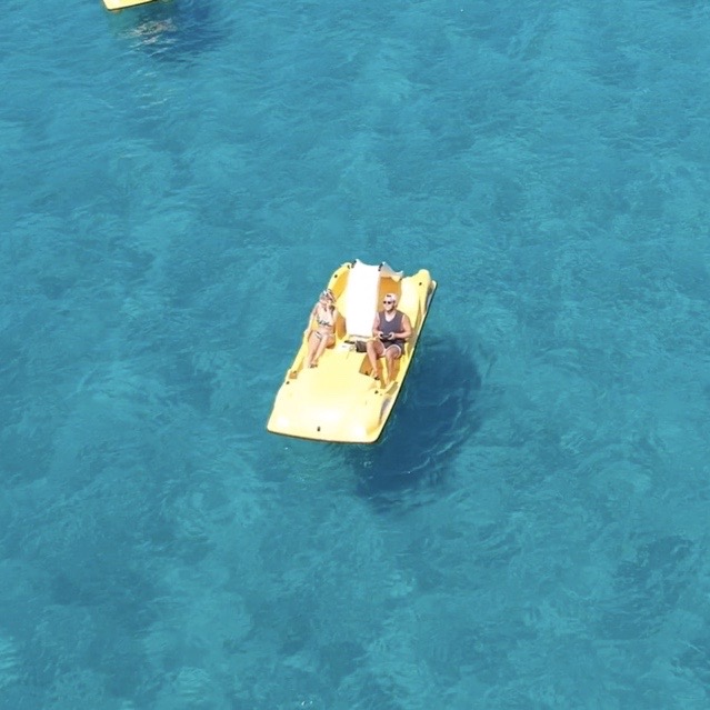 Couple on a pedal boat in the sea as part of the lassi, kefalonia guide.