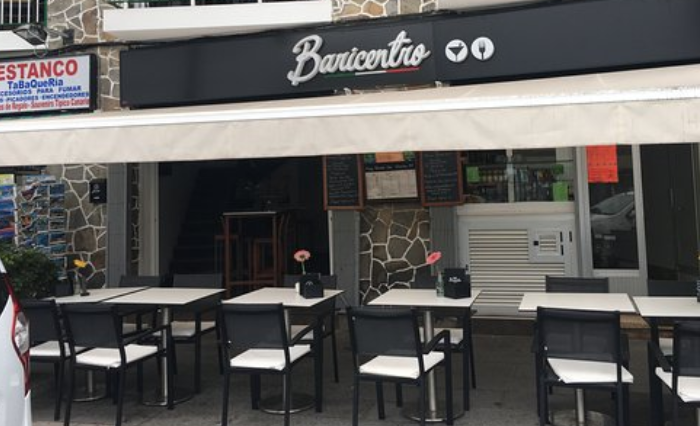 A picture of a restaurant with tables outside as part of where to stay in Tenerife.