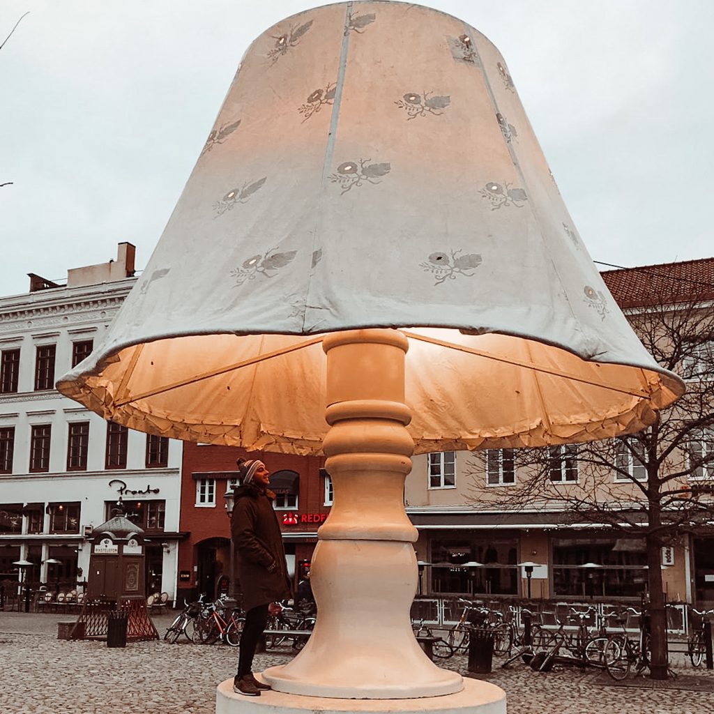 Huge lamp lit up in a city square