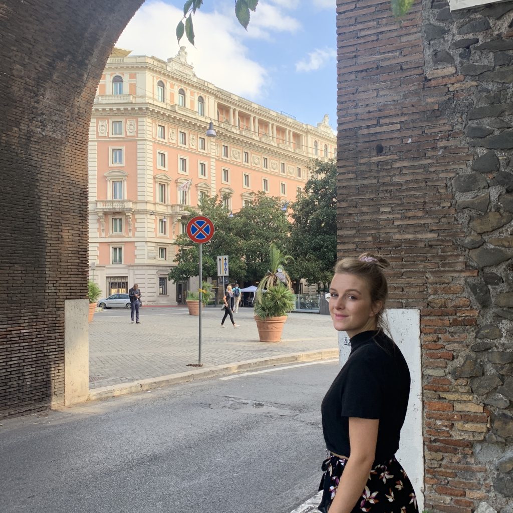 A woman entering through a wall near Villa Borghese gardens