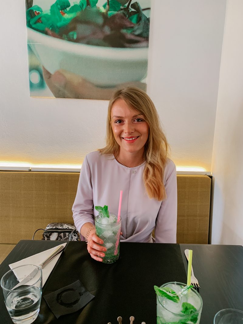 A girl posing with a Mojito cocktail