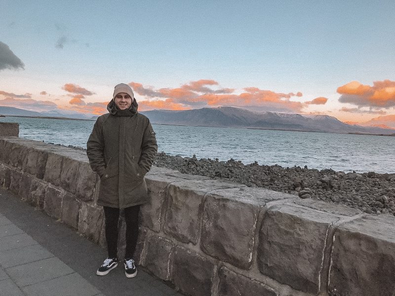 A view of Reykjavik bay with sea and mountains in the background during sunset. Things to do in Iceland