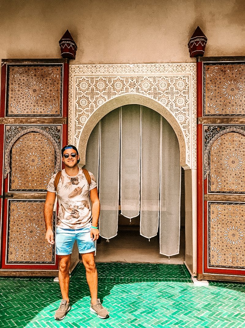 Le Jardin Secret. Man infront of entrance as part of the Morocco travel guide