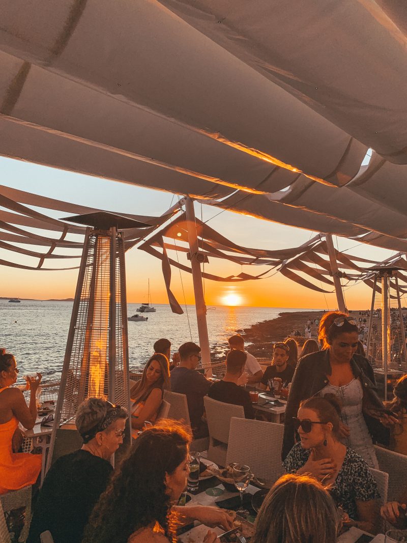 Sunset in Cafe Mambos bar with the ocean in the background. Things to do in Ibiza