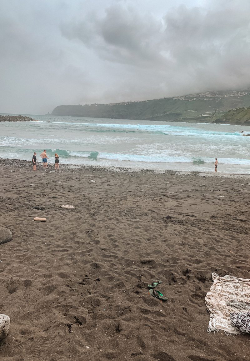 Black sandy beach with blue waves. Things to do in Tenerife