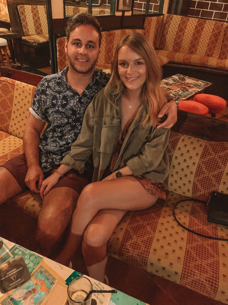 A couple sat on a couch in a bar. Where to stay in Tenerife
