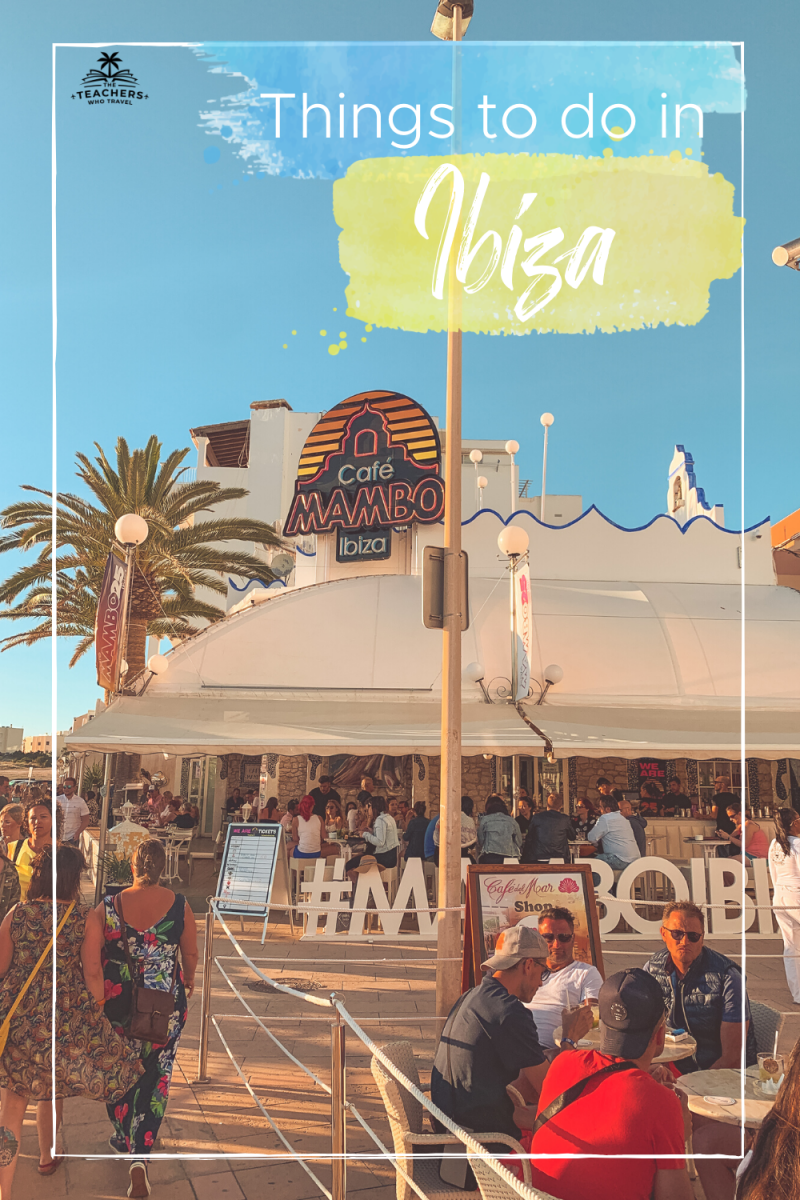 Cafe Mambo in San Antonio with palm trees and people and a blue sky. Things to do in Ibiza on a budget.