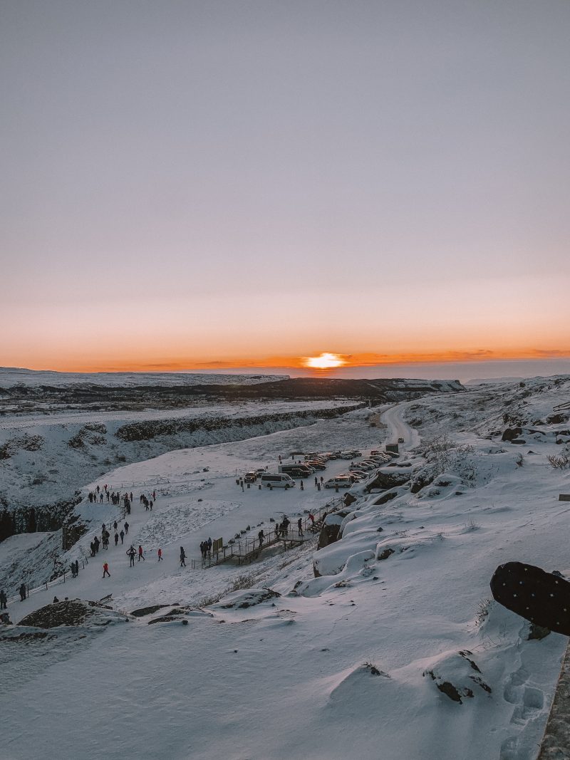 Behind Gullfoss waterfall the sun is setting. Things to do in Iceland