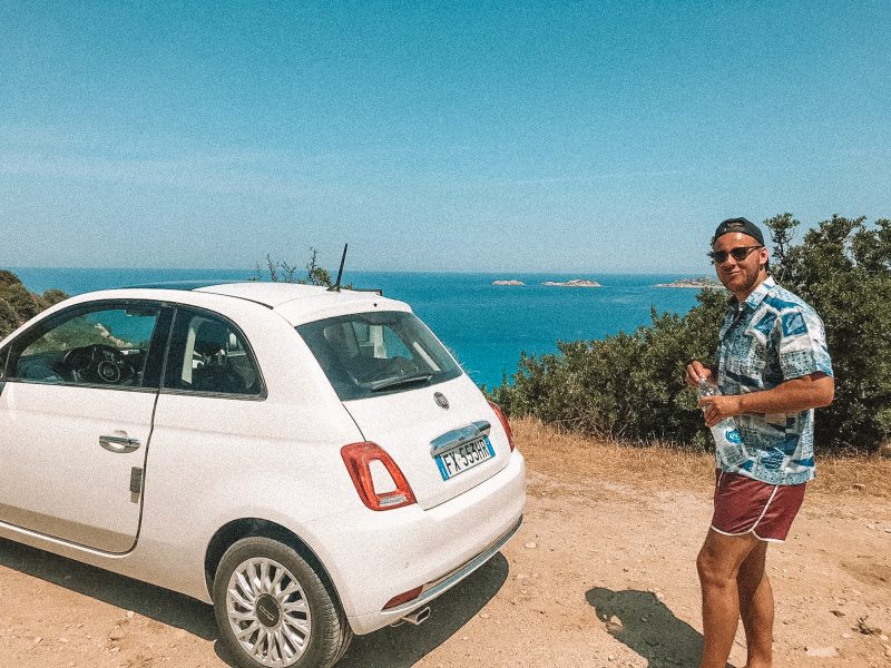 A man with a Fiat 500 car. Things to do in Sardinia