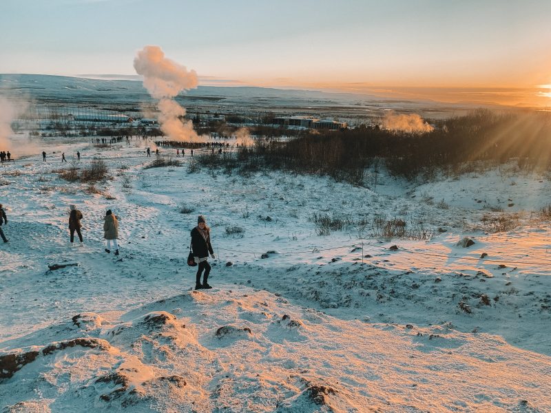 Stokkur Geysir with thick clouds of smoke coming from the snowy ground