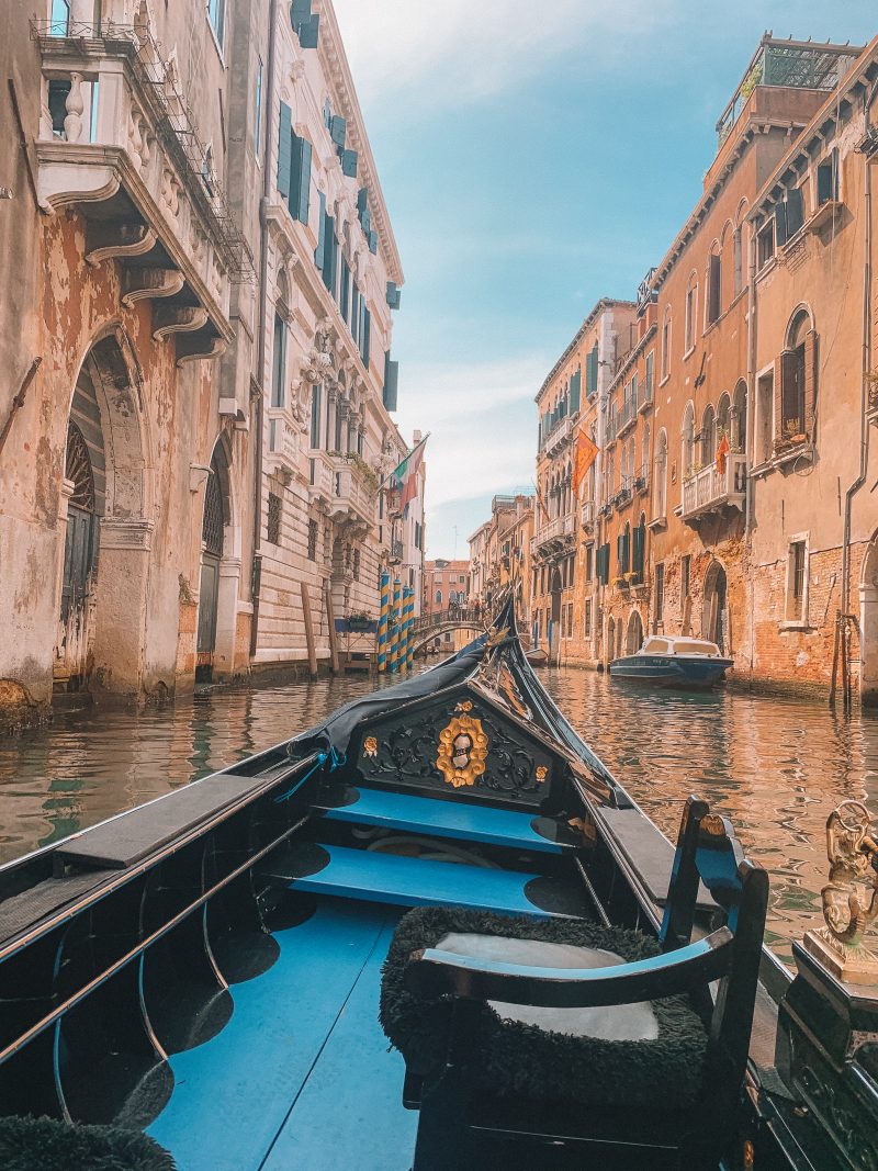 A gondola in between buildings for seeing Venice in a day