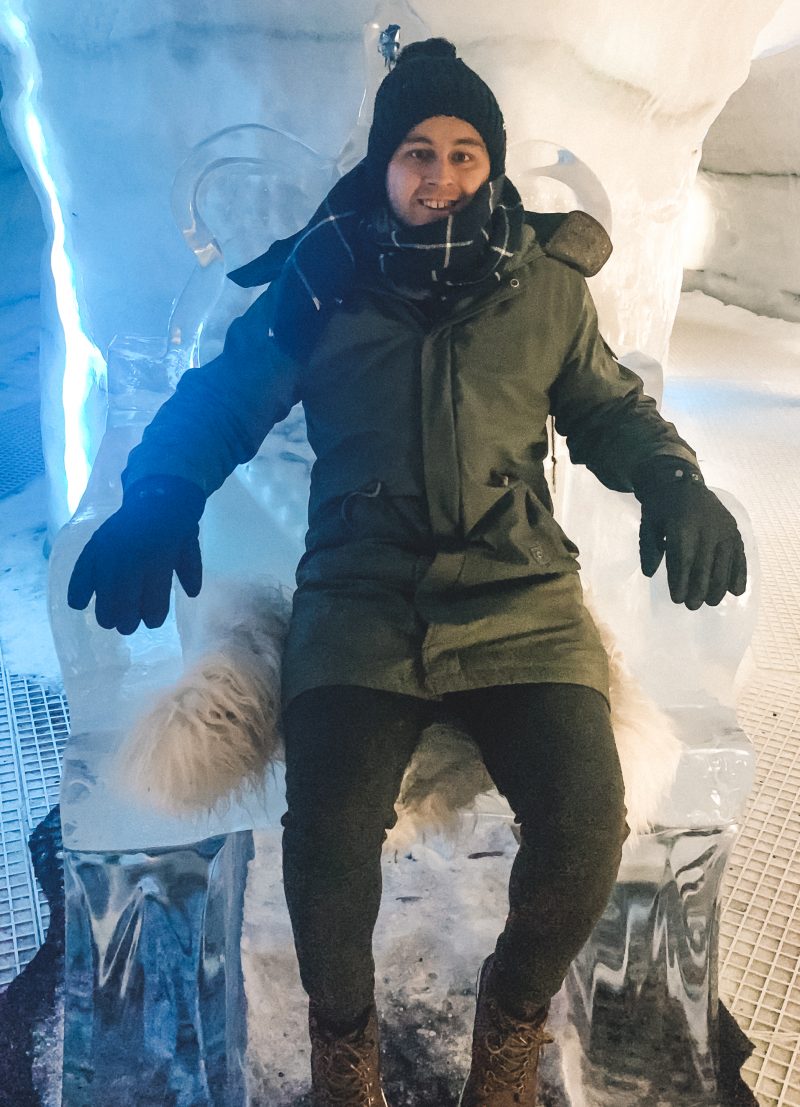 A man sat on an ice throne as part of what to do in Iceland