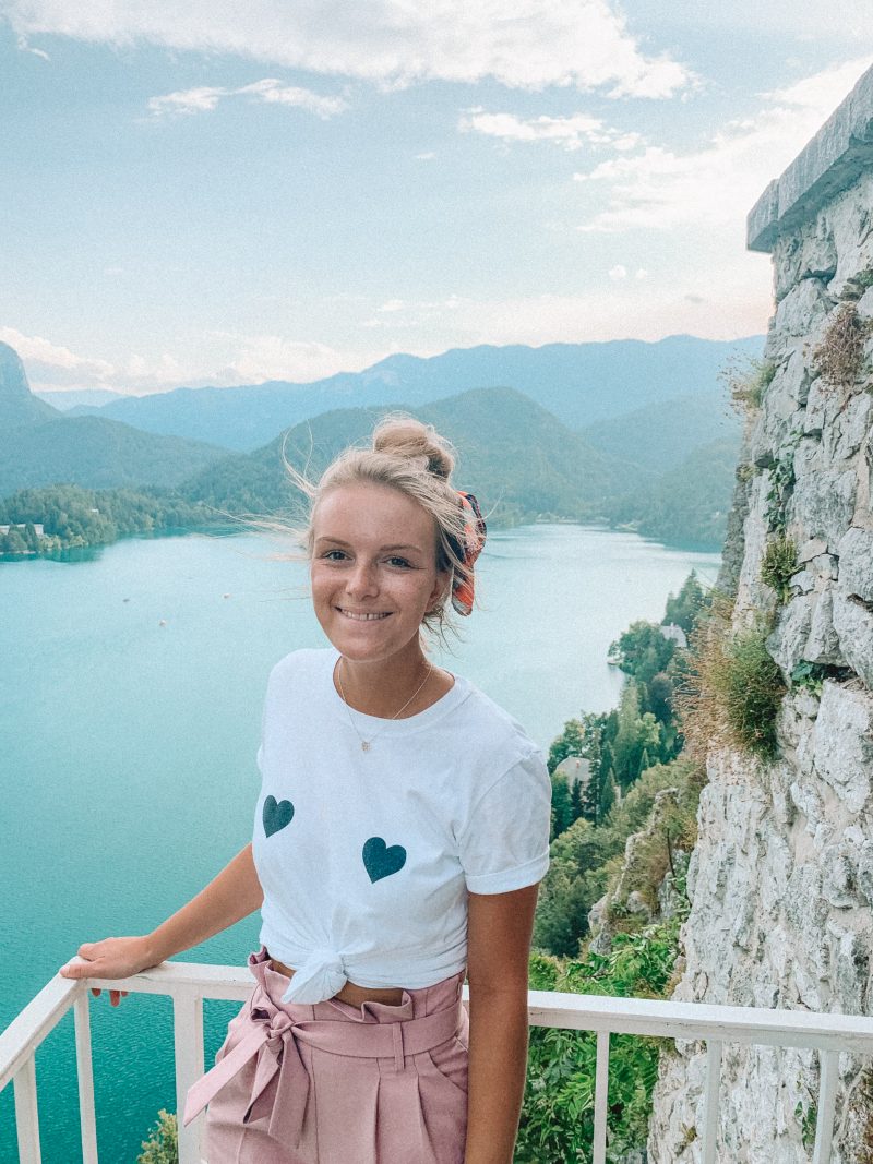 A woman smiling at the top of Bled castle. What to do at Lake Bled