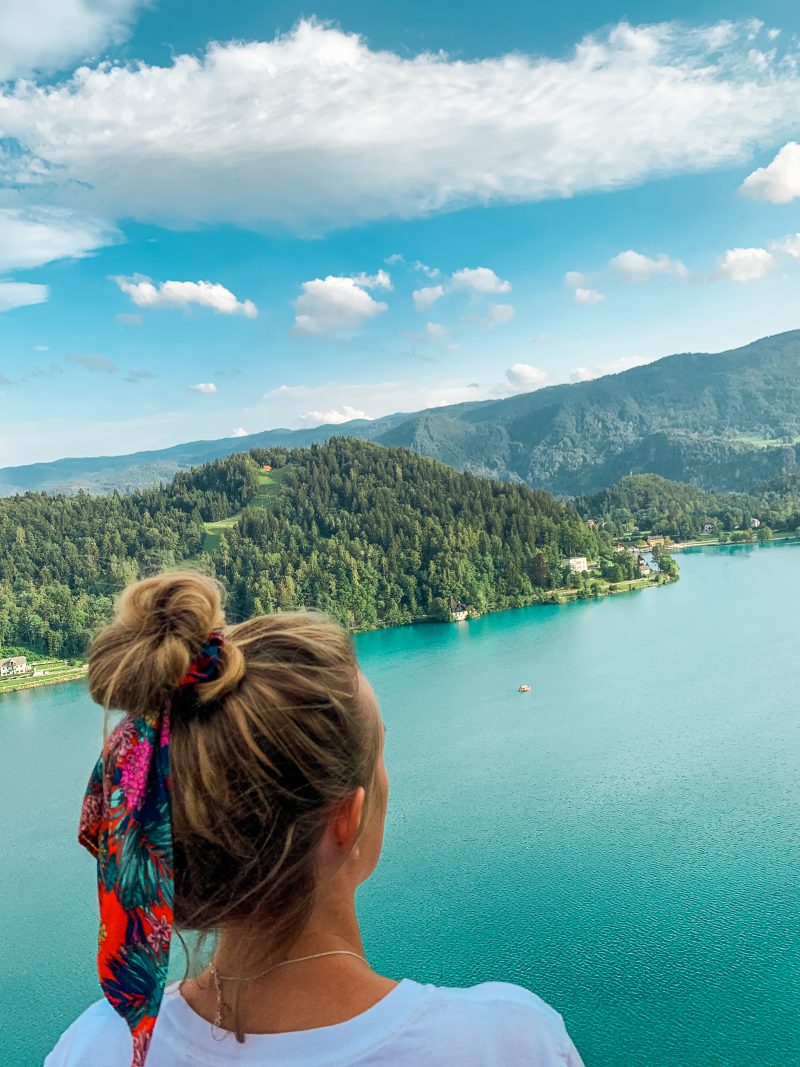 A woman looking at Lake Bled from the castle. What to do in Lake Bled