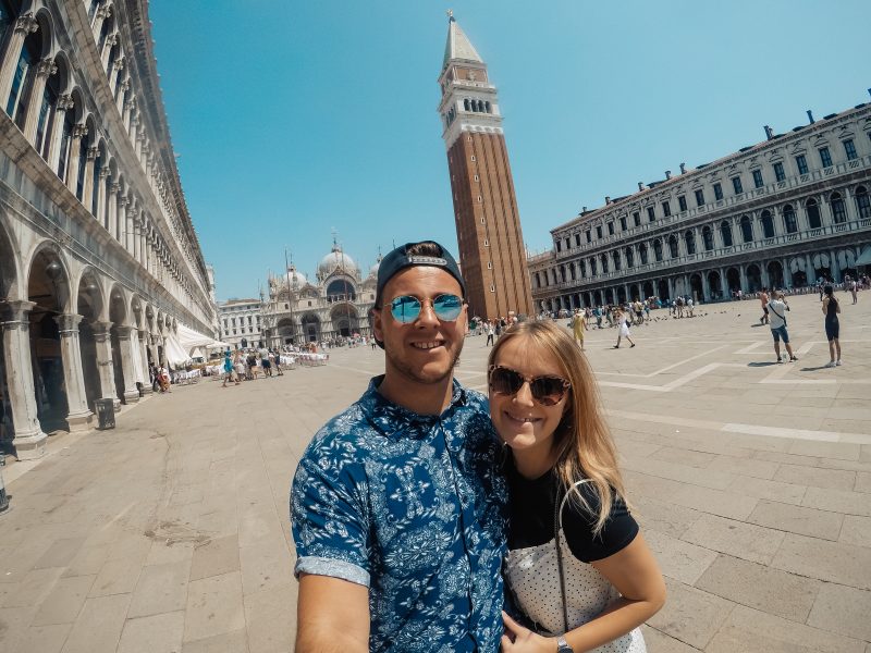 A couple stood in San Marco square with buildings around them. What to do in Venice