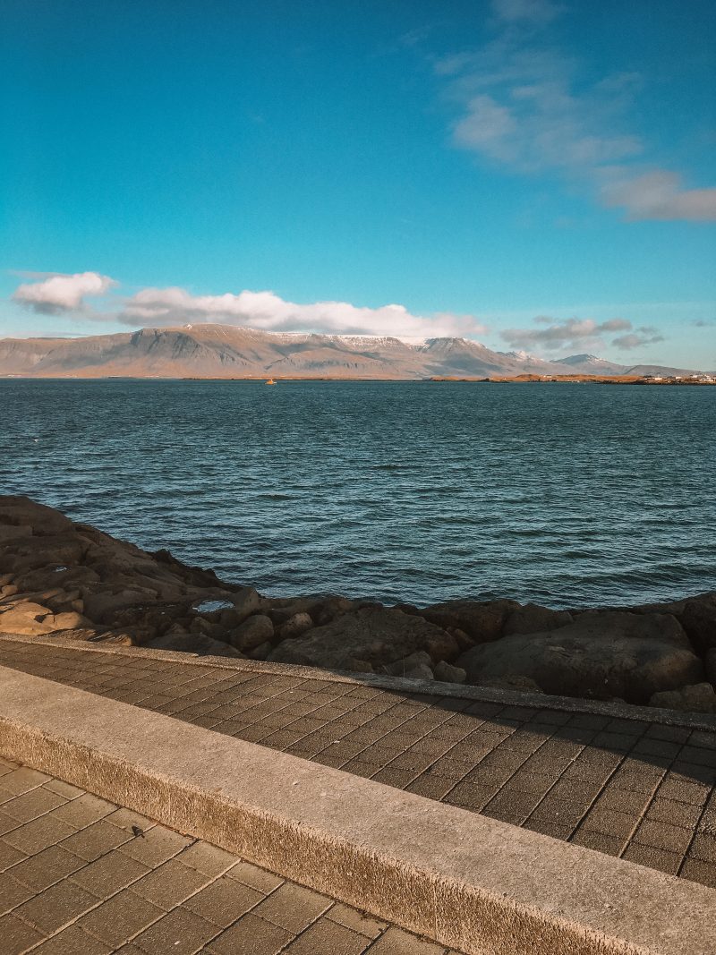 The ocean with mountains in the background in Reykjavik, Iceland