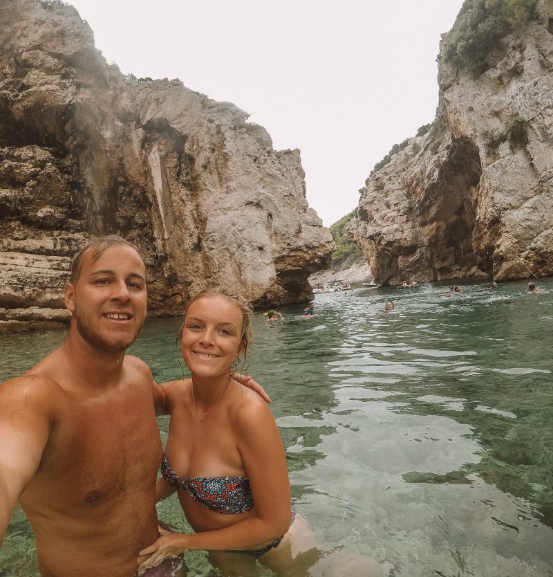 A couple taking a selfie in the sea water in Vis. Where to go in Hvar