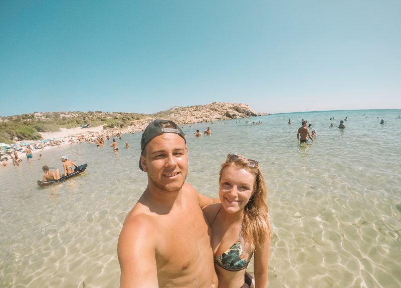A couple taking a selfie at Tuerredda beach in Sardinia