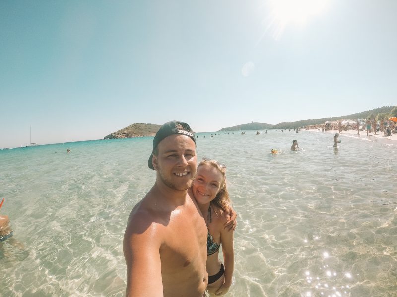 Things to do at Tuerredda beach. A couple in the sea taking a sefie