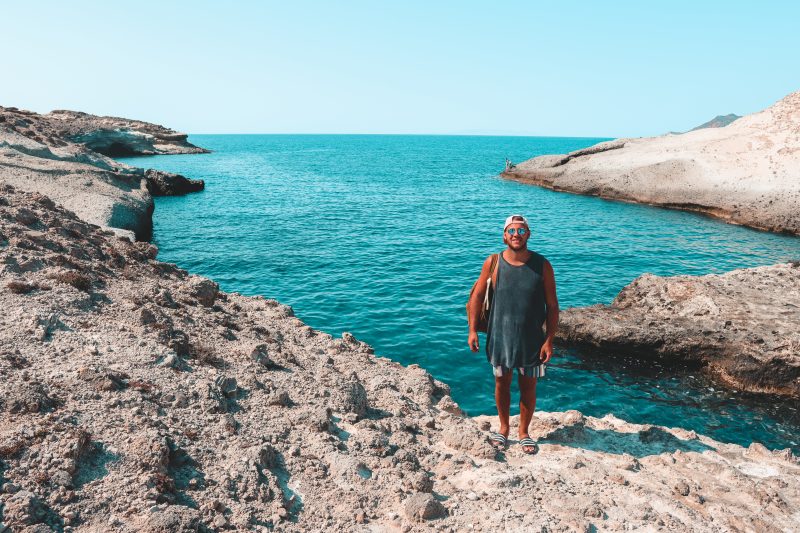 A man infront of turquoise water at Kapros beach