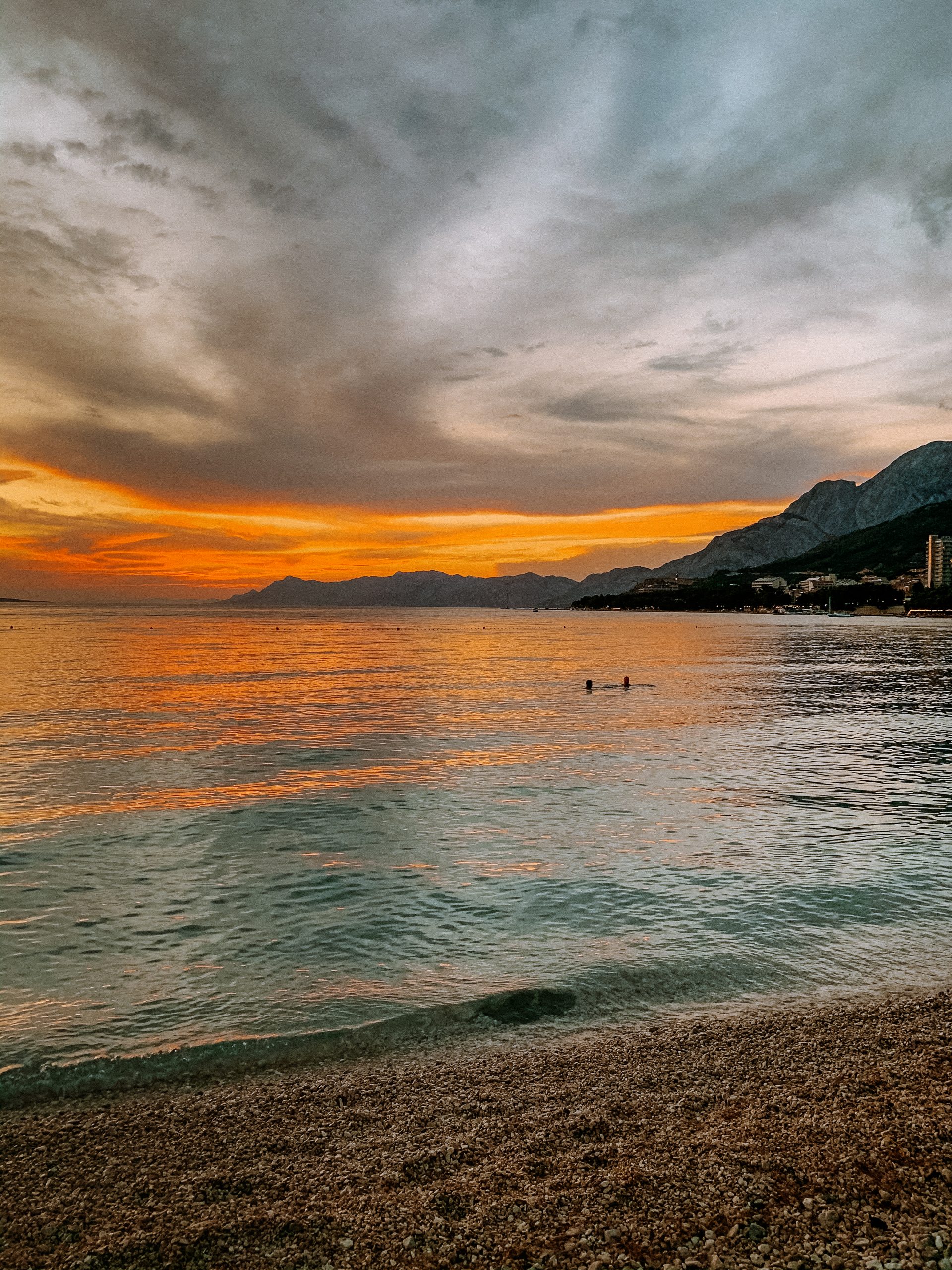 A couple in the sea during the sunset. Things to do in Makarska