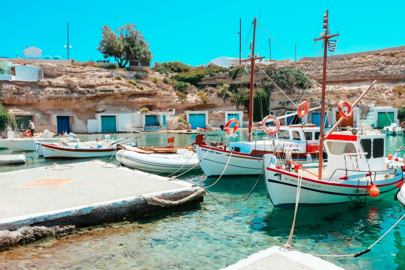 Boats and turquoise waters at a fishing village in Milos