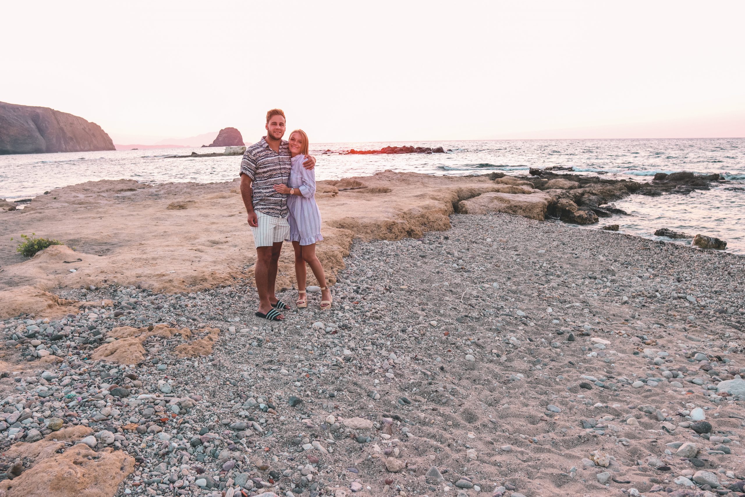 A couple having a selfie during sunset in Pollonia, Milos