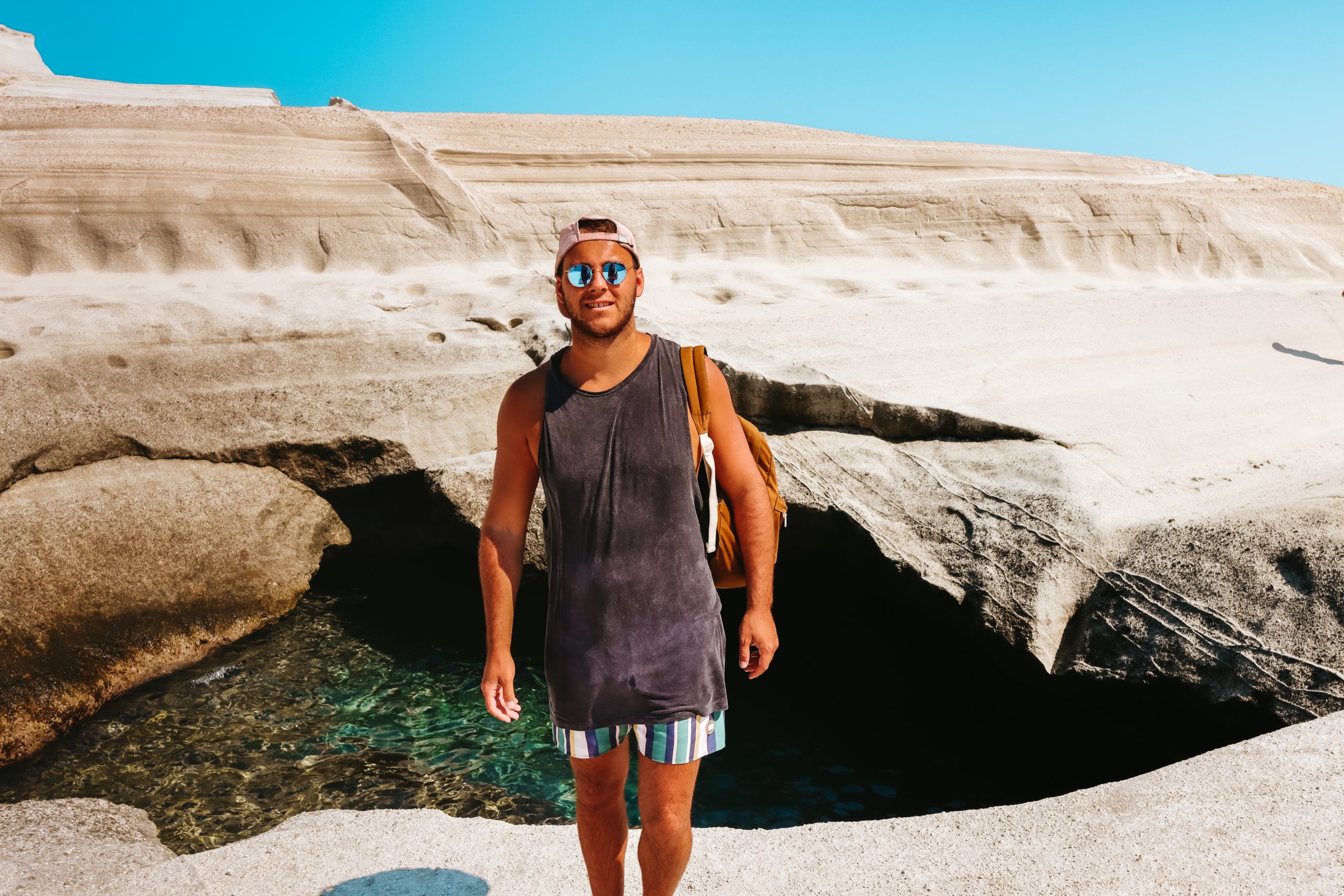 A man stood by the rocks at Sarakiniko beach. Things to do in Milos