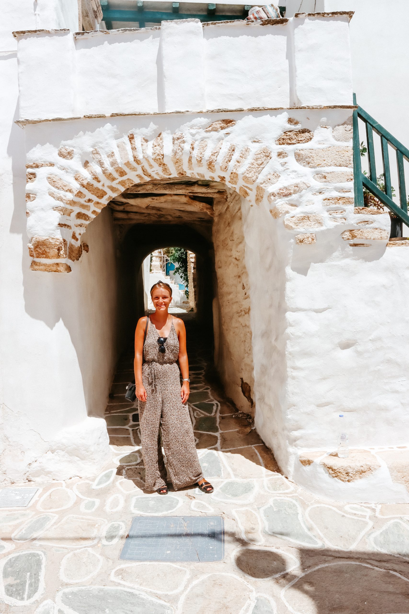 A woman stood in a tunnel at Folegandros Castro.