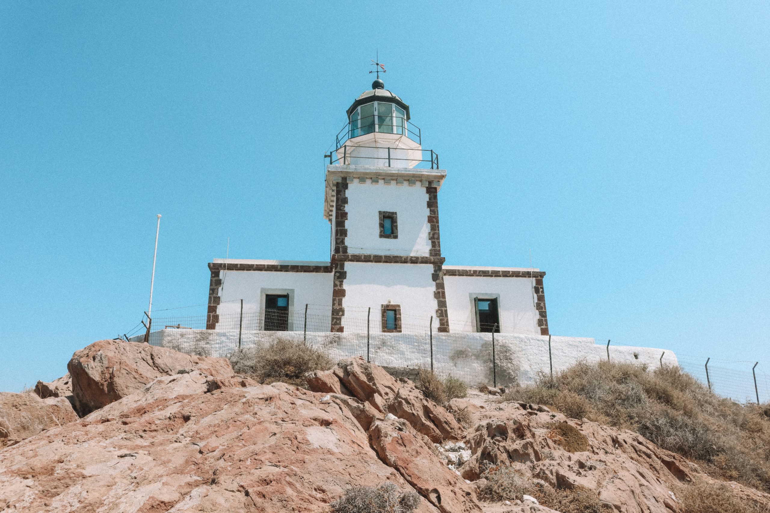 A whitewashed lighthouse in Akrotiri, Santorini