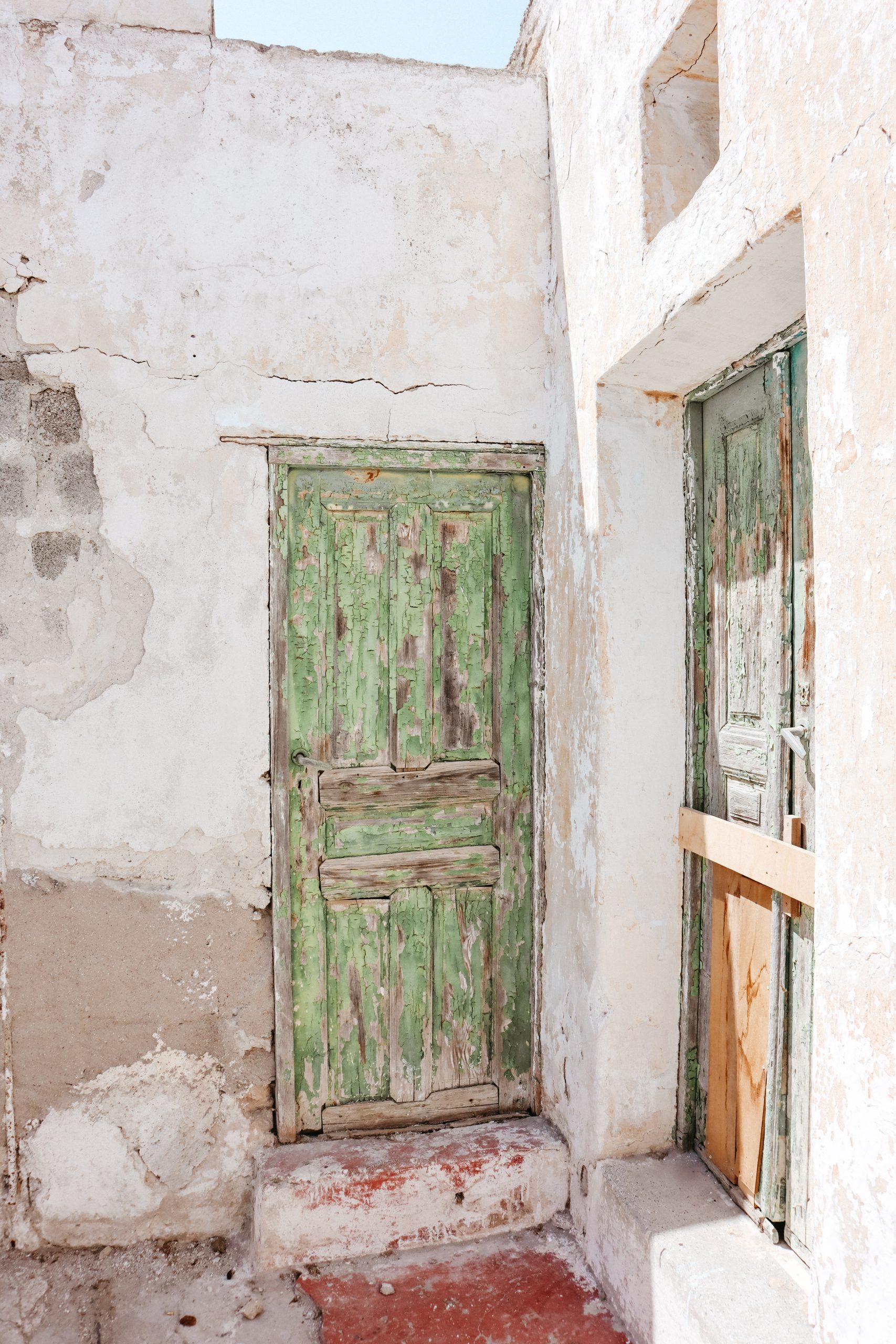 A green painted wooden door in Megalochori village