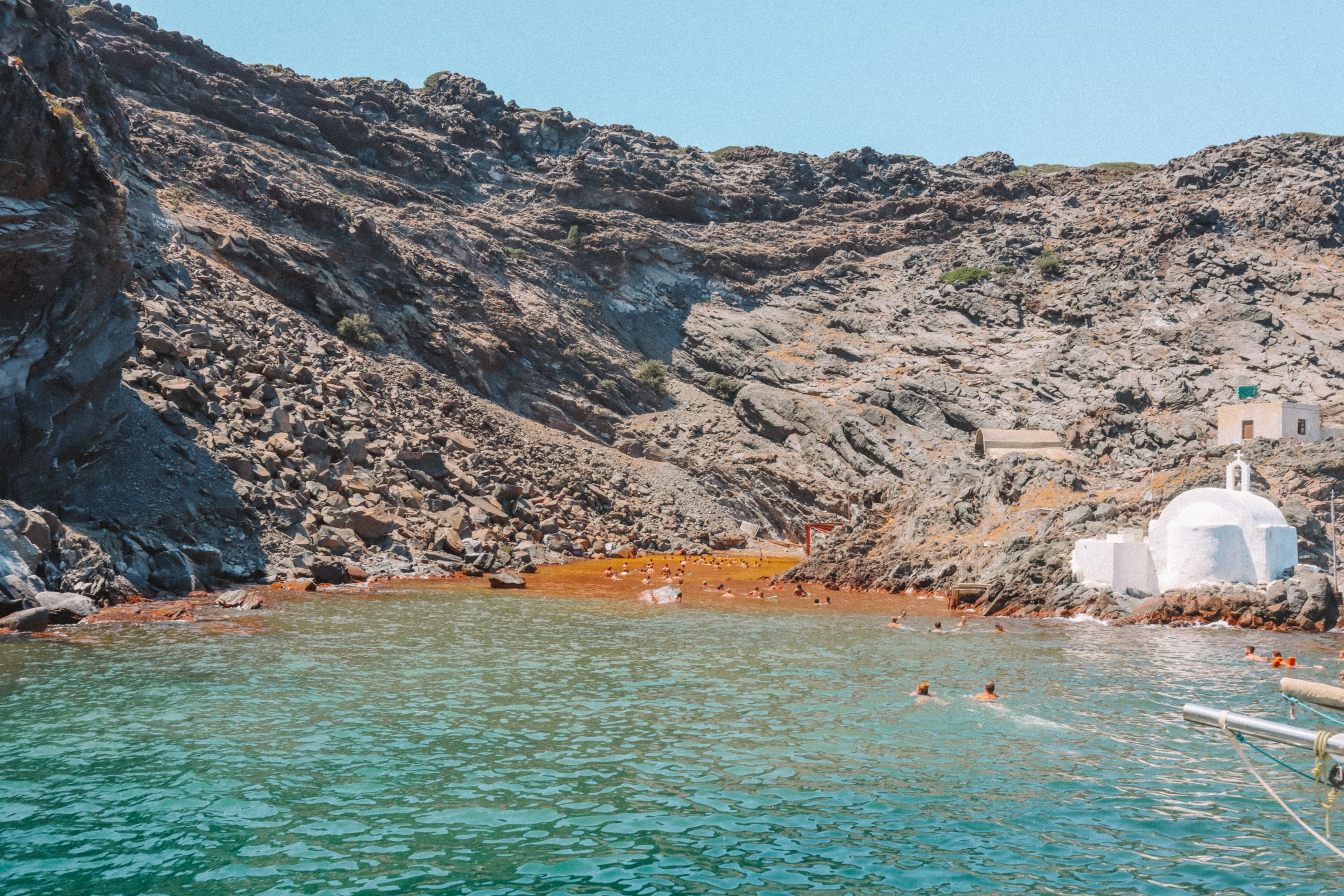 Palea Kameni volcanic springs with whitewashed churches. Things to see in Santorini
