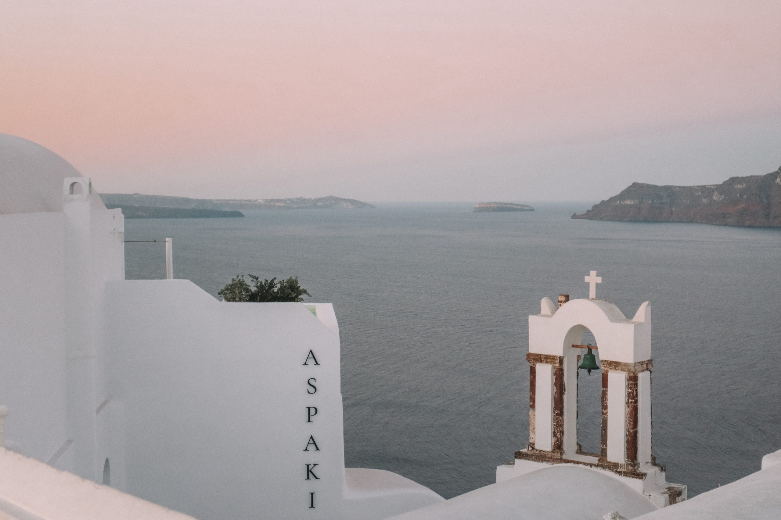 Whitewashed churches with the sunrise in the background.
