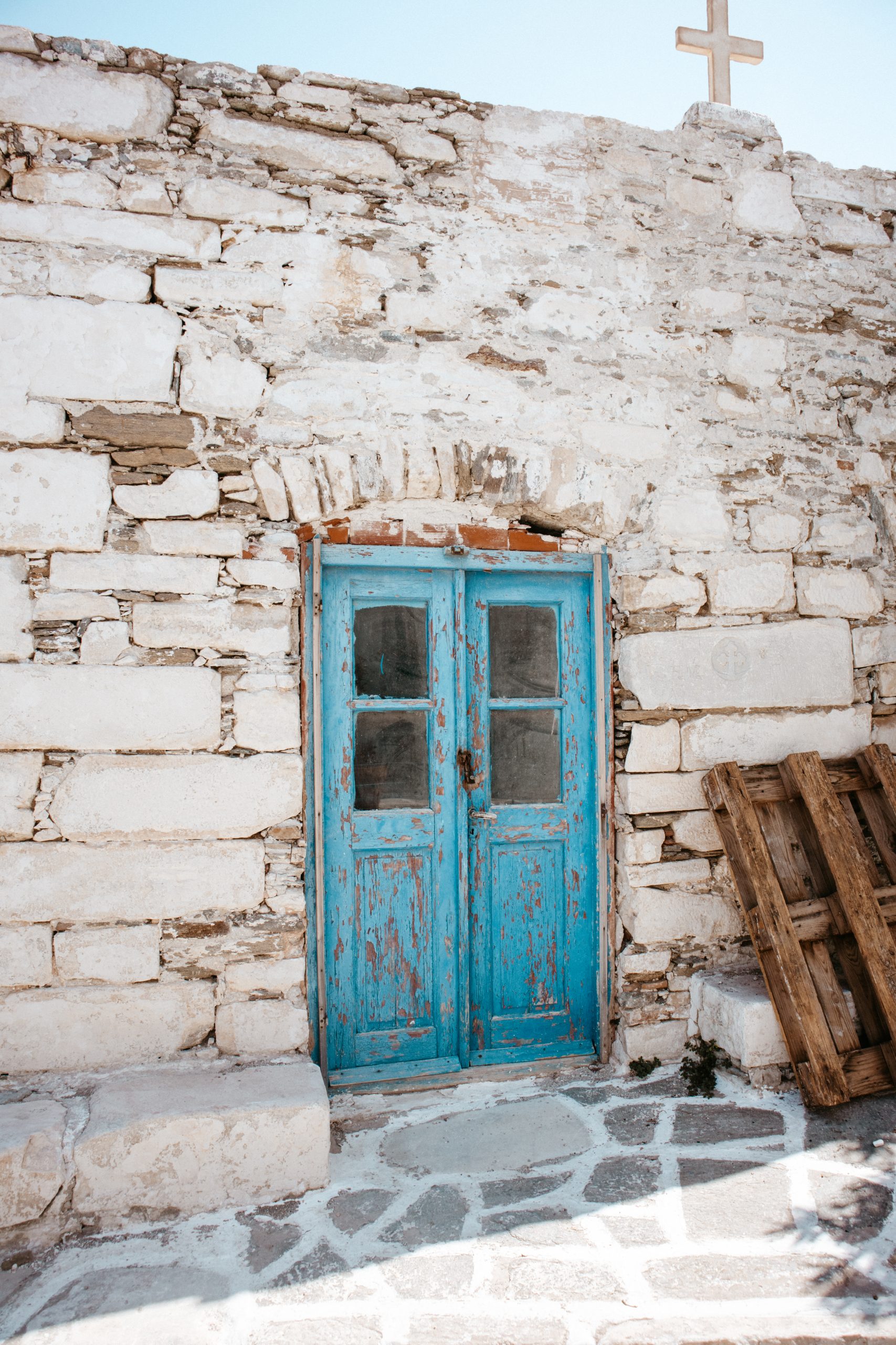An old building with a blue door in Parakia, Paros.