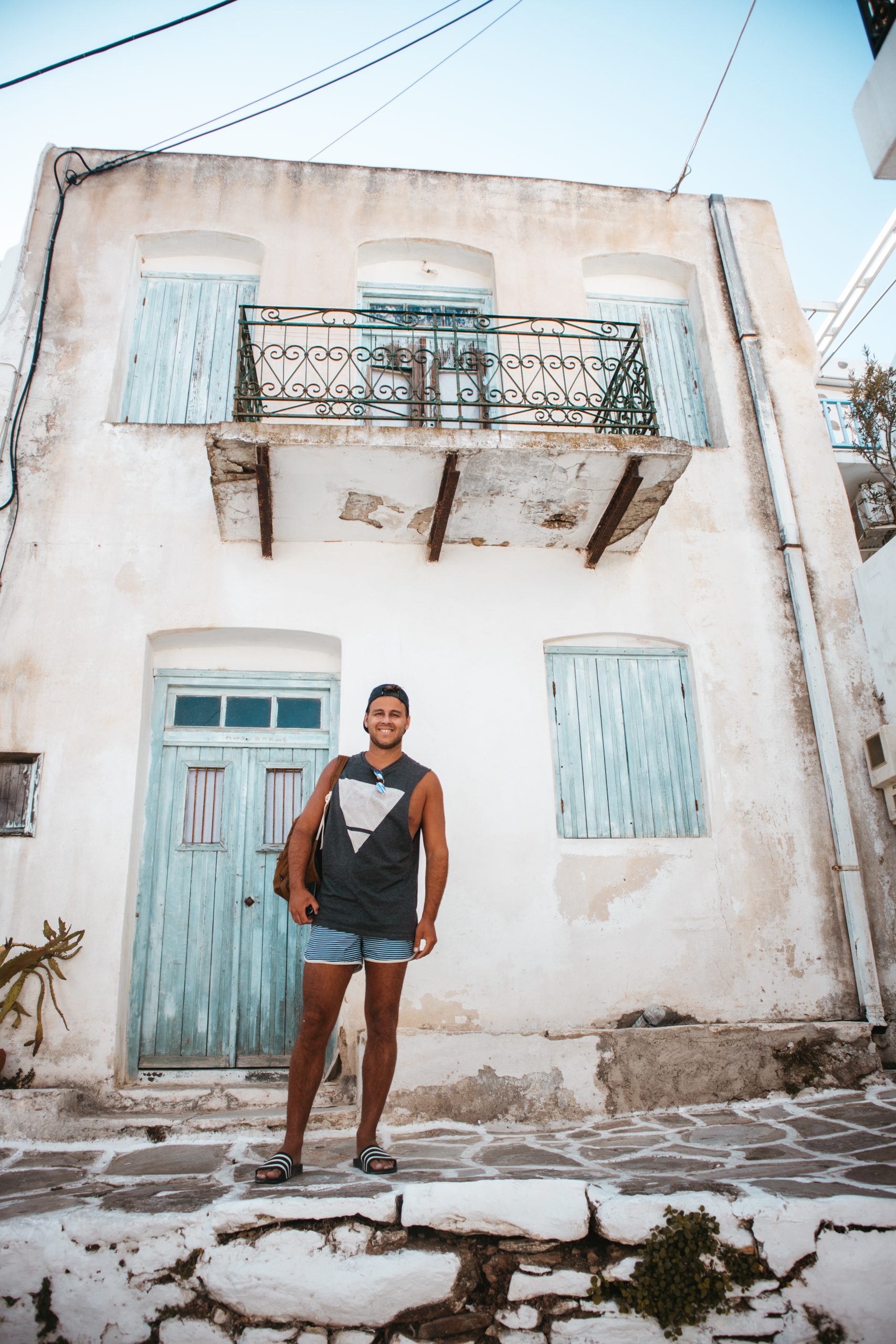 A man stood in front of a house in Lefkes village, Paros