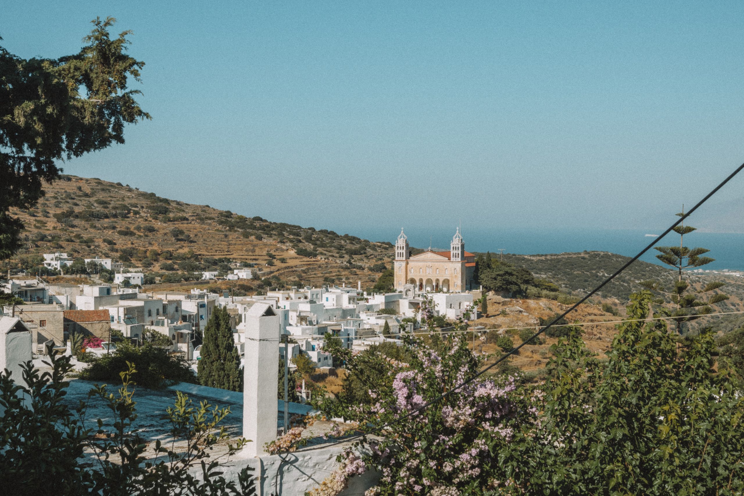 A far out view of Lefkes village with the sea in the background. Things to do in Paros