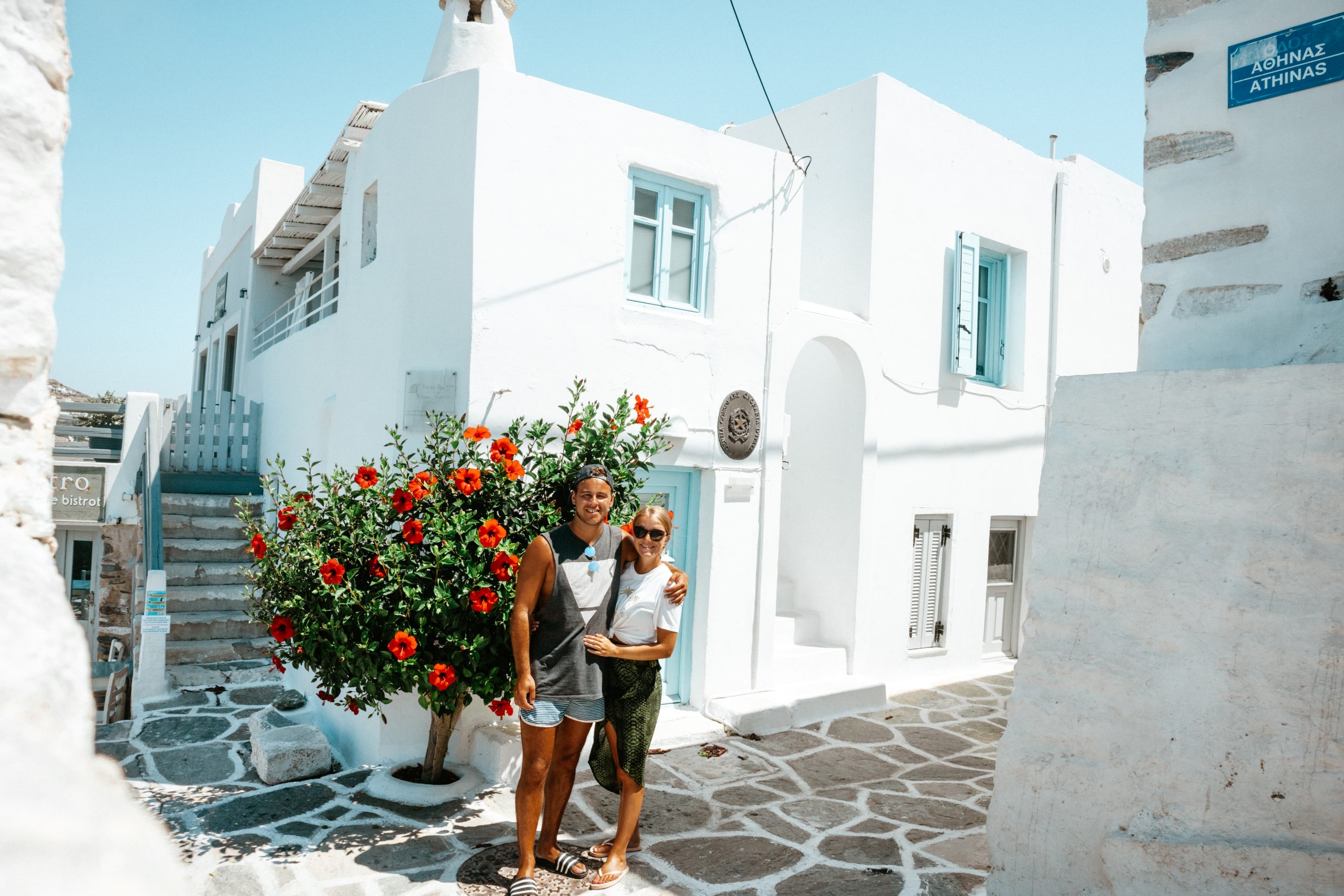 A couple stood in the alleyway of Parakia, Paros. Things to see in Paros