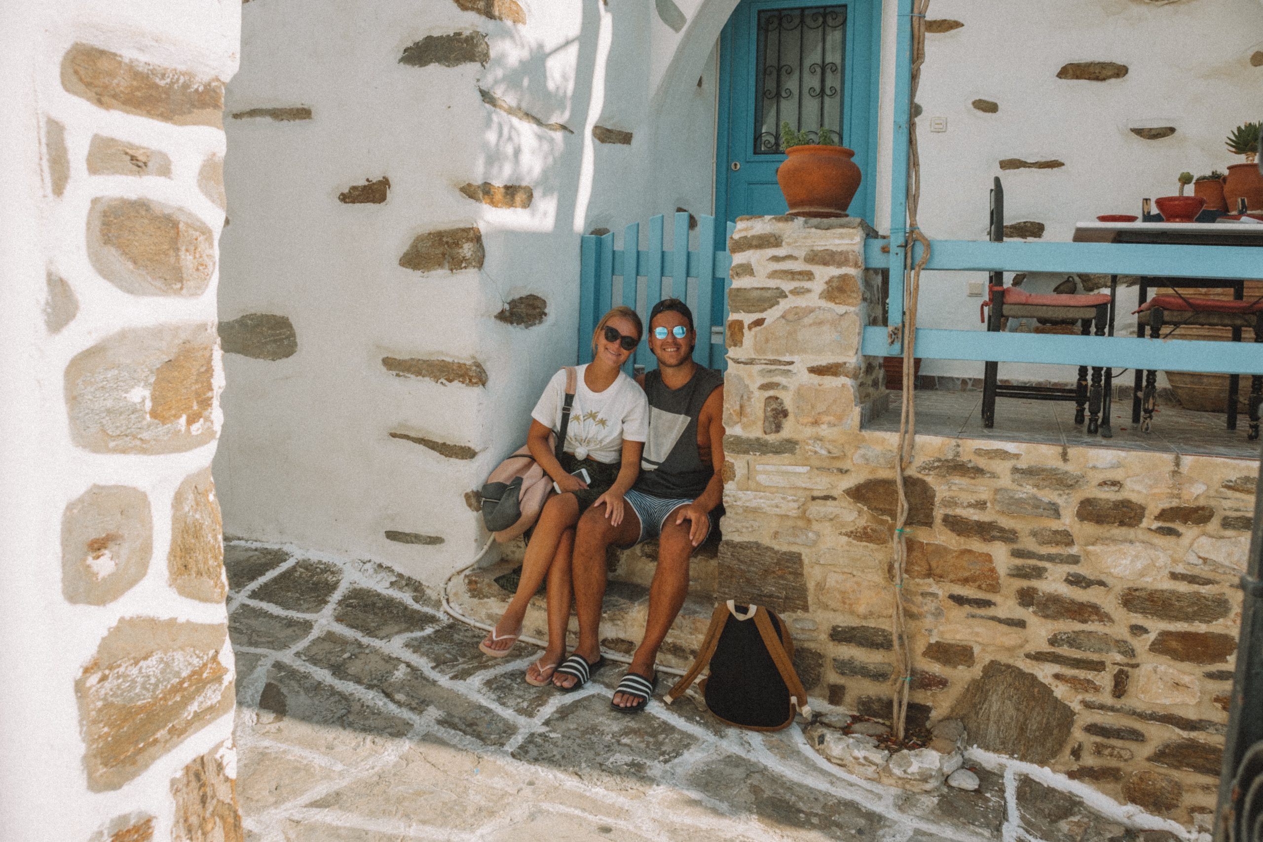 A couple sat in front of a Lefkes village house. Things to see in Paros