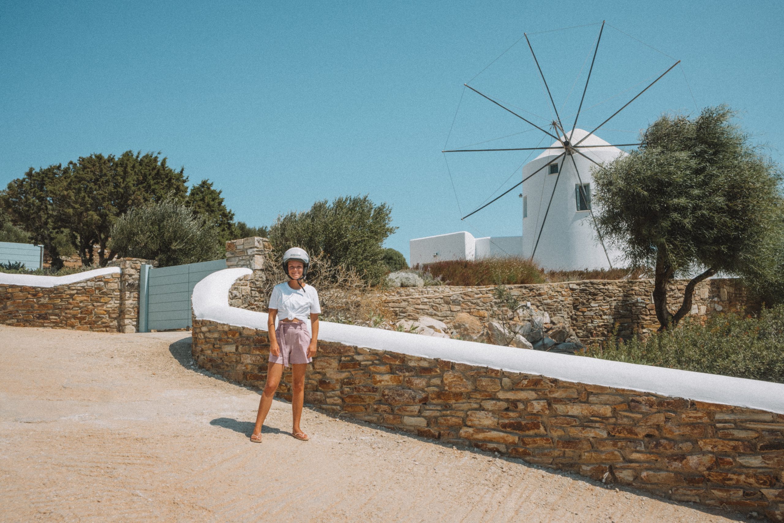 A woman next to a white windmill in Antiparos. Antiparos travel blog